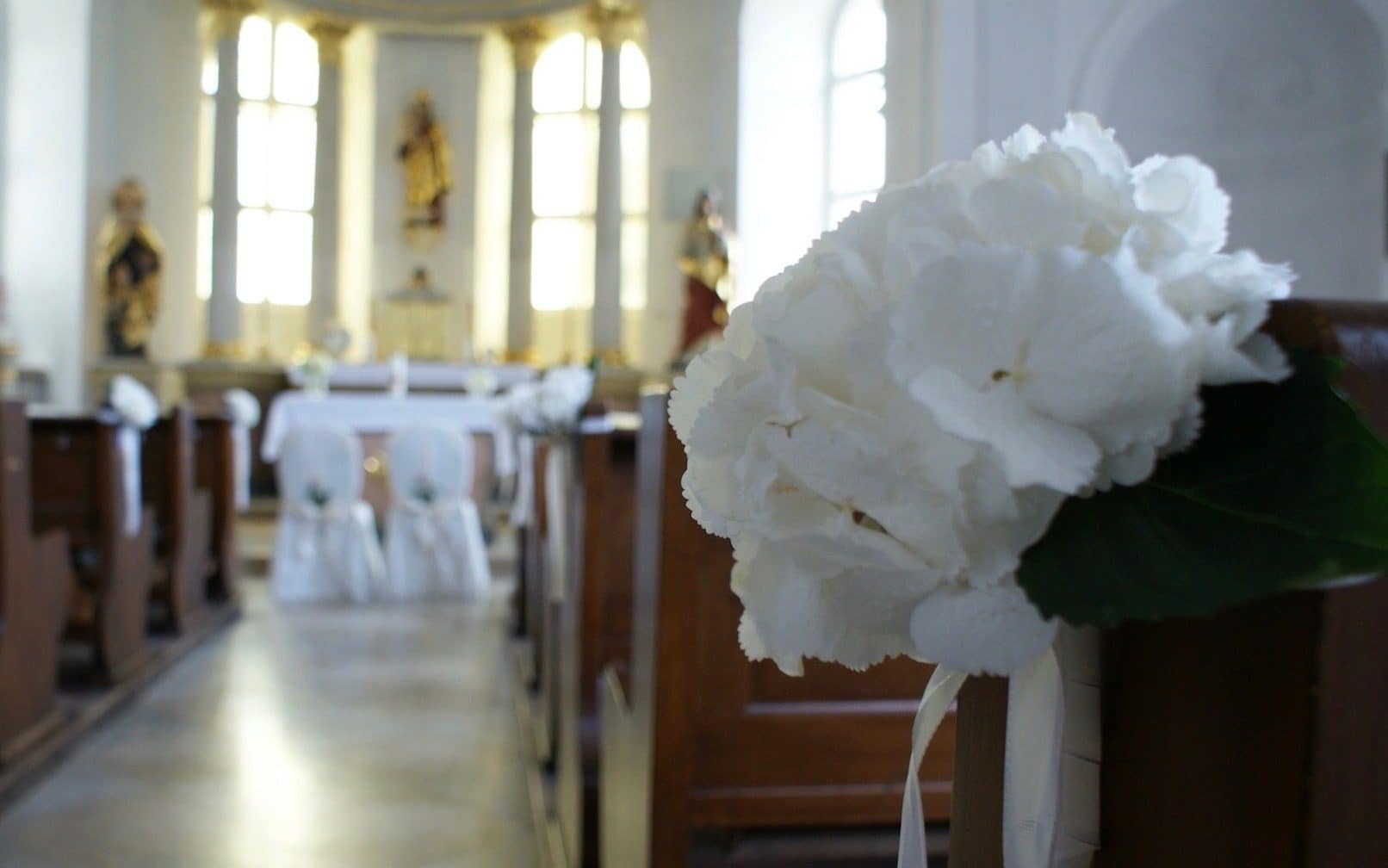 Schlosskapelle geschmückt mit weissem Blumenbouquet